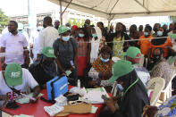 Nigeria civil servants wait to receive an AstraZeneca vaccine, in Abuja, Nigeria, Wednesday, Dec. 1, 2021. Nigeria has detected its first case of the omicron coronavirus variant in a sample it collected in October, weeks before South Africa alerted the world about the variant last week, the country's national public health institute said Wednesday. (AP Photo/Gbemiga Olamikan)