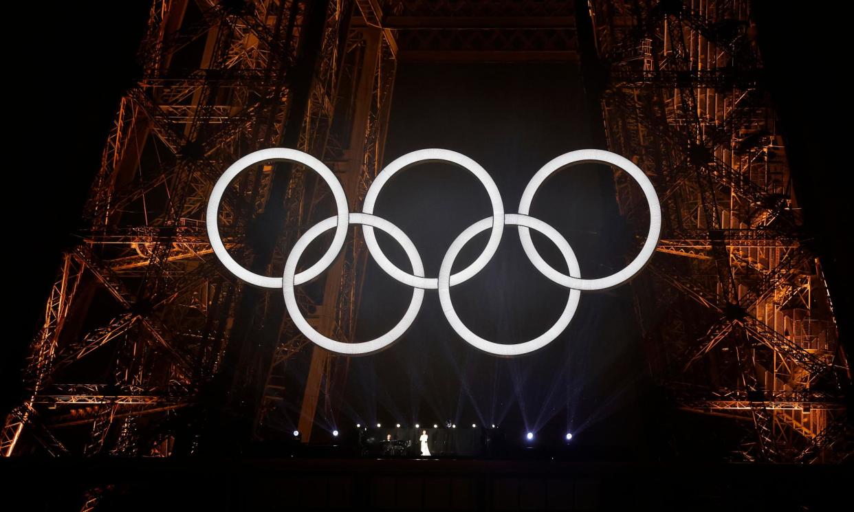 <span>Rescue act: Céline Dion performs from beneath the Olympic rings on the Eiffel Tower.</span><span>Photograph: Tom Jenkins/The Guardian</span>