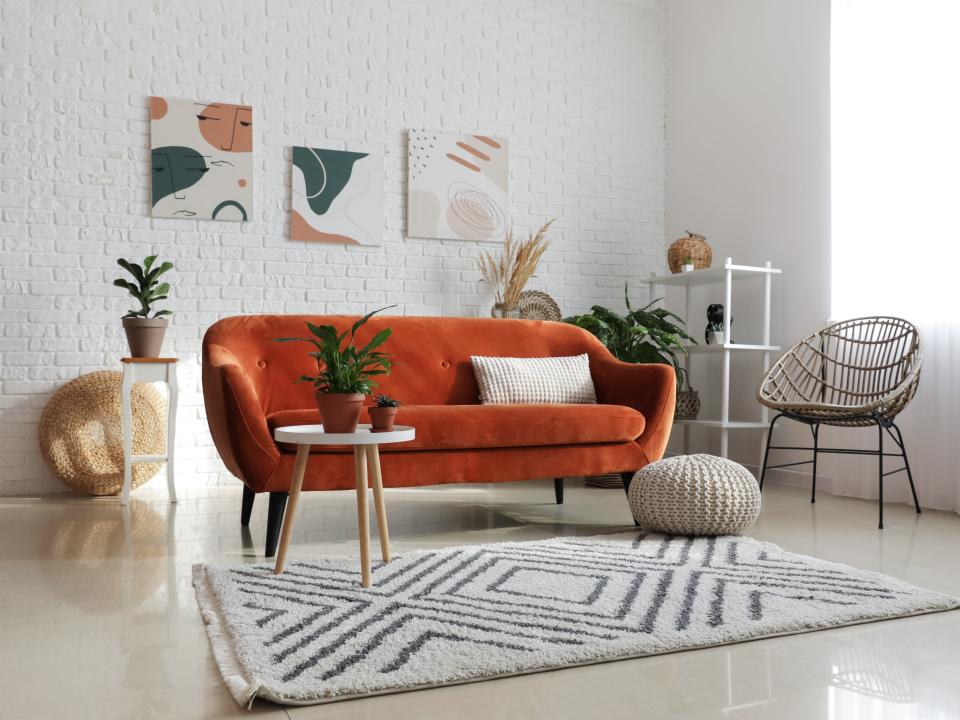 orange curved couch in a living room