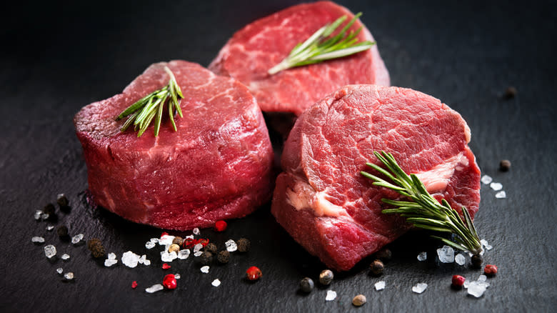 Raw filet mignon cuts on black background 