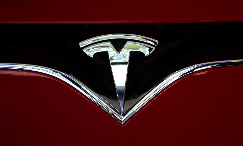 Tesla logo on the nose of a vehicle