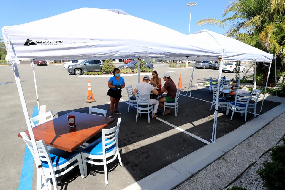 Diners outside Cruisers Grill in Jacksonville Beach as Florida entered phase one of the plan to reopen the state.