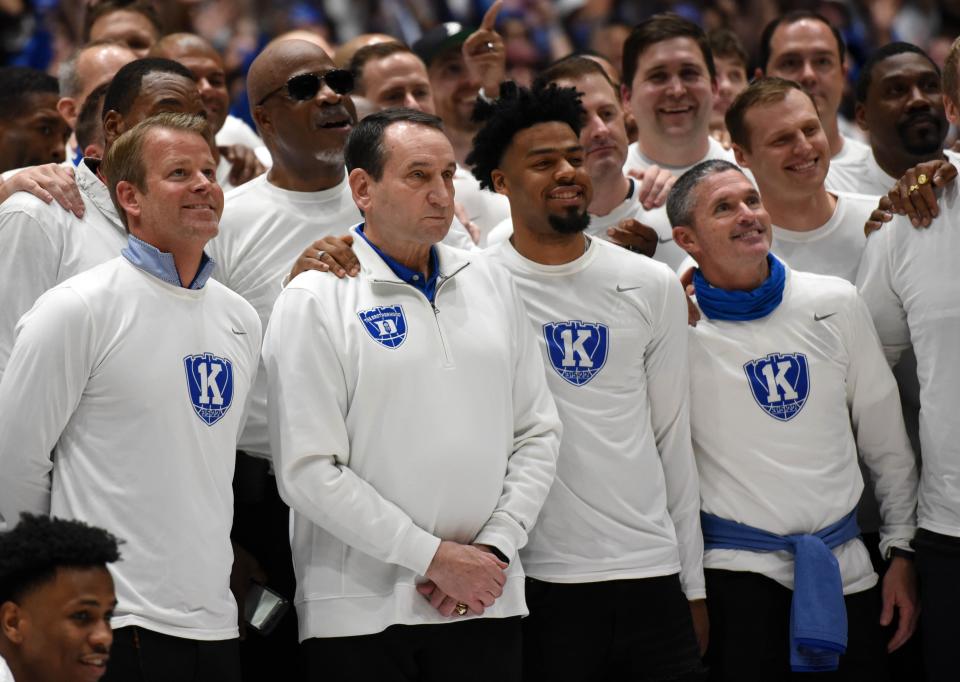 Mike Krzyzewski poses for a picture with former players before Saturday's game.