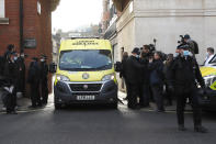 Police officers stand at an entrance to the King Edward VII Hospital where Prince Philip is being treated for an infection, as an ambulance is driven out, in London, Monday, March 1, 2021. (AP Photo/Frank Augstein)