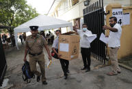 Sri Lankan polling officers carry election material as they dispatch them to polling centers ahead of the parliamentary elections in Colombo, Sri Lanka, Tuesday, Aug. 4, 2020. Sri Lankans are voting in parliamentary elections Wednesday that are expected to strengthen President Gotabaya Rajapaksa's grip on power. Parts of the party are also calling for a two-thirds majority in Parliament so it can amend the constitution to restore presidential powers curbed by a 2015 constitutional change. (AP Photo/Eranga Jayawardena)