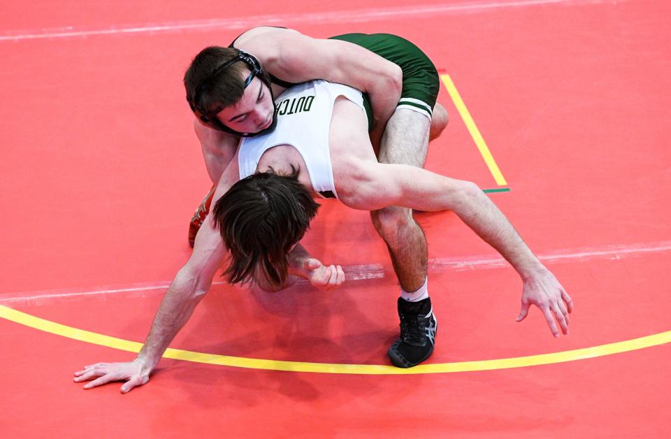 Southeast Polk's Andon Trout, top, wrestles Pella's Peyton Ritzert at 138 pounds during the Class 3A district tournament at Carlisle High School on Saturday.