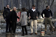 President Donald Trump talks with from left, Gov.-elect Gavin Newsom, California Gov. Jerry Brown, Mayor of Paradise Jody Jones and FEMA Administrator Brock Long during a visit to a neighborhood destroyed by the wildfires, Saturday, Nov. 17, 2018, in Paradise, Calif. (AP Photo/Evan Vucci)