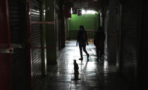 Cloth venders prepare to open their shops amid fears of the new coronavirus outbreak at a market in Jakarta, Indonesia Friday, May 22, 2020. (AP Photo/Achmad Ibrahim)