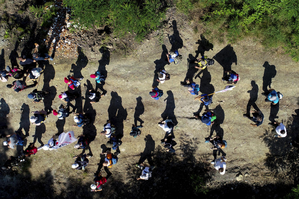 Participants take part in the "March of Peace", march to remember the 1995 Srebrenica massacre, in Nezuk, Bosnia, Saturday, July 8, 2023. A solemn peace march started on Saturday through forests in eastern Bosnia in memory of the 1995 Srebrenica massacre, Europe's only acknowledged genocide since World War II. The 100-kilometre (60-mile) march traces a route taken by Bosniak men and boys as they tried to flee Srebrenica after it was captured by Bosnian Serb forces in the closing days of the country's interethnic war in the 1990s. (AP Photo/Armin Durgut)