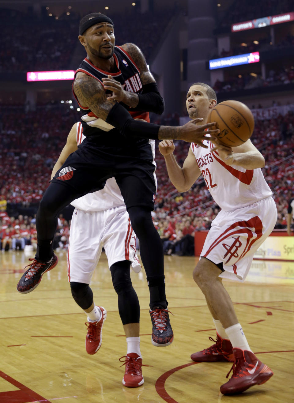 Portland Trail Blazers' Mo Williams (25) passes the ball around Houston Rockets' Francisco Garcia (32) during the second quarter in Game 1 of an opening-round NBA basketball playoff series Sunday, April 20, 2014, in Houston. (AP Photo/David J. Phillip)