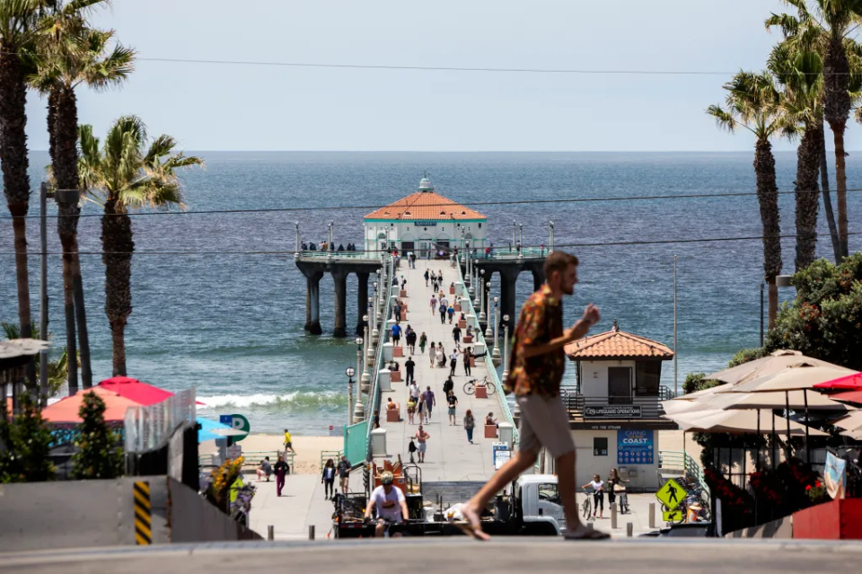 People make their way along the Manhattan Beach Pier in Manhattan Beach on May 27, 2022.