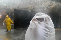 <p>A woman covers herself with a plastic bag as she makes her way to work as Hurricane Maria approaches the coast of Bavaro, Dominican Republic, Wednesday, Sept. 20, 2017. (Photo: Tatiana Fernandez/AP) </p>