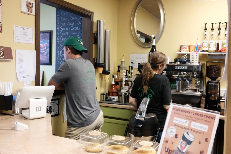 The staff at Uptown Joe in Louisville use a new espresso machine in late July 2022.