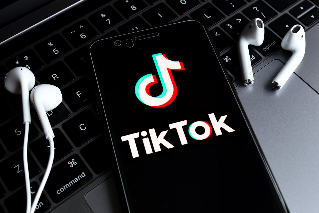 HAIKOU, HAINAN, CHINA - 2020/08/23: In this photo illustration, a TikTok logo seen displayed on a smartphone with a computer in the background. ByteDance, parent company of popular video-sharing app TikTok on Sunday confirmed it would be filing a lawsuit on Monday local time against the Trump administration over the executive order signed by President Donald Trump banning its service in the United States. (Photo Illustration by Sheldon Cooper/SOPA Images/LightRocket via Getty Images)