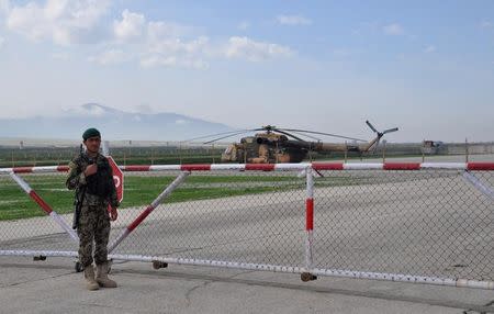 An Afghan soldier in front of a Mi-17 transport helicopter of the Afghan air force in Mazar-i-Sharif, Afghanistan on March 28, 2017. Picture taken March 28, 2017. REUTERS/Sabine Siebold