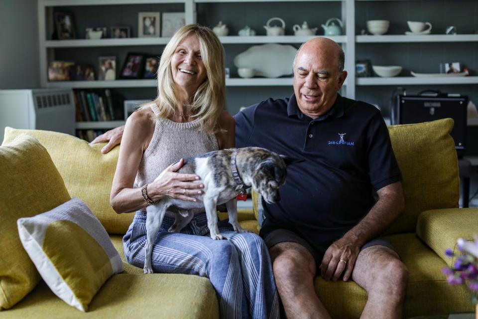 Jan, 64, and Gary Rosenberg, of Huntington Woods sit in the family room with their Chihuahua mix Dylan and where they would spend the most time with Miles, their 16-year-old Puggle that passed away recently, on Saturday, Aug. 5, 2023.