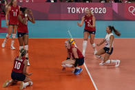 Players from the United States react after defeating Brazil to win the gold medal in women's volleyball at the 2020 Summer Olympics, Sunday, Aug. 8, 2021, in Tokyo, Japan. (AP Photo/Frank Augstein)