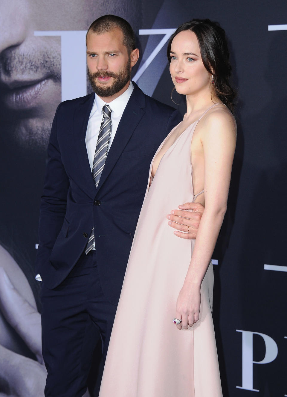 jamie's arm around dakota at the movie premiere