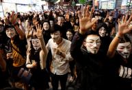 Protesters wearing Guy Fawkes masks attend an anti-government demonstration in Hong Kong