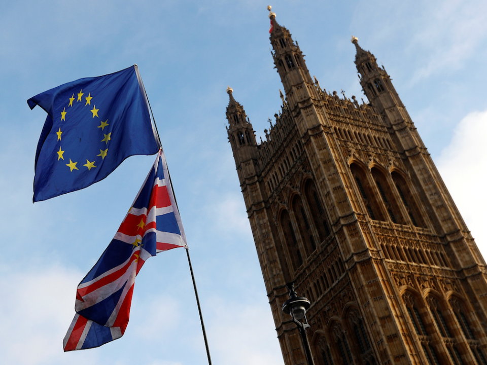 Protesters wave the EU and Union flags outside the Palace of Westminster, London, December 20, 2017