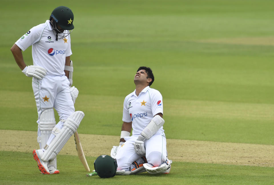 Pakistan's Abid Ali, right, reacts in pain after he was hit on a delivery by England's Chris Woakes during the first day of the second cricket Test match between England and Pakistan, at the Ageas Bowl in Southampton, England, Thursday, Aug. 13, 2020. (Glyn Kirk/Pool via AP)