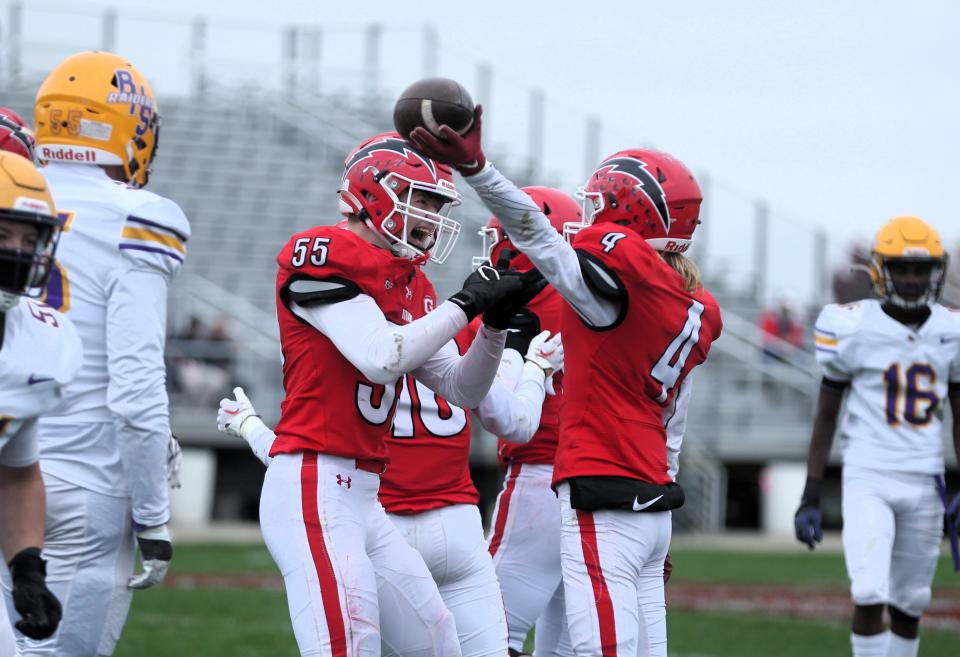 Chatham Glenwood's Justin Hay, left, celebrates a fumble recovery by Tyson Dunbar, right, during the first round of the Class 6A high school football playoffs against visiting Bloomington on Saturday, Oct. 28, 2023.