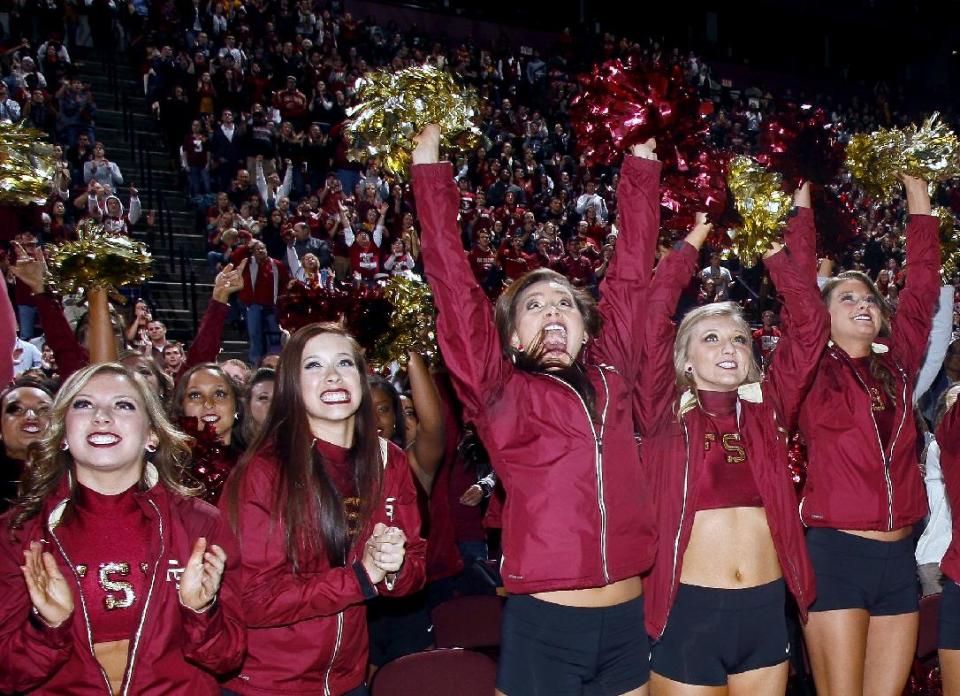 Florida State Golden Girls cheerleaders react as they watch Florida State score a touchdown on a 30-foot screen at the Tallahassee Leon County Civic Center in the second quarter of the NCAA BCS National Championship college football game against Auburn, Monday, Jan. 6, 2014, in Tallahassee, Fla. (AP Photo/Phil Sears)