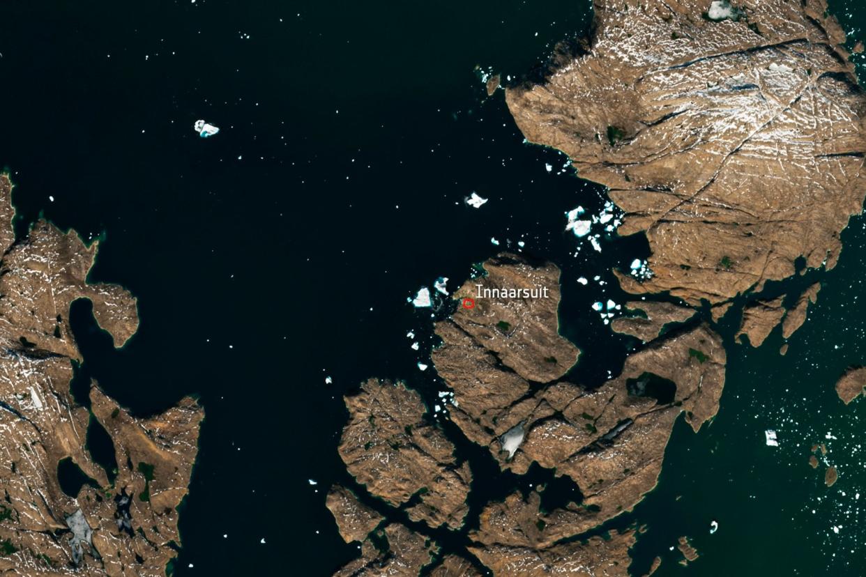 The satellite image shows a huge iceberg perilously close to the village of Innaarsuit: AP