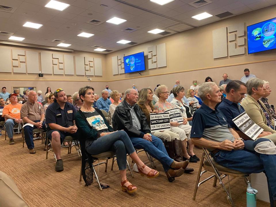 People packed the San Angelo City Council meeting room on Tuesday, Oct. 5, 2021, several holding signs in support of making San Angelo a sanctuary city for the unborn.