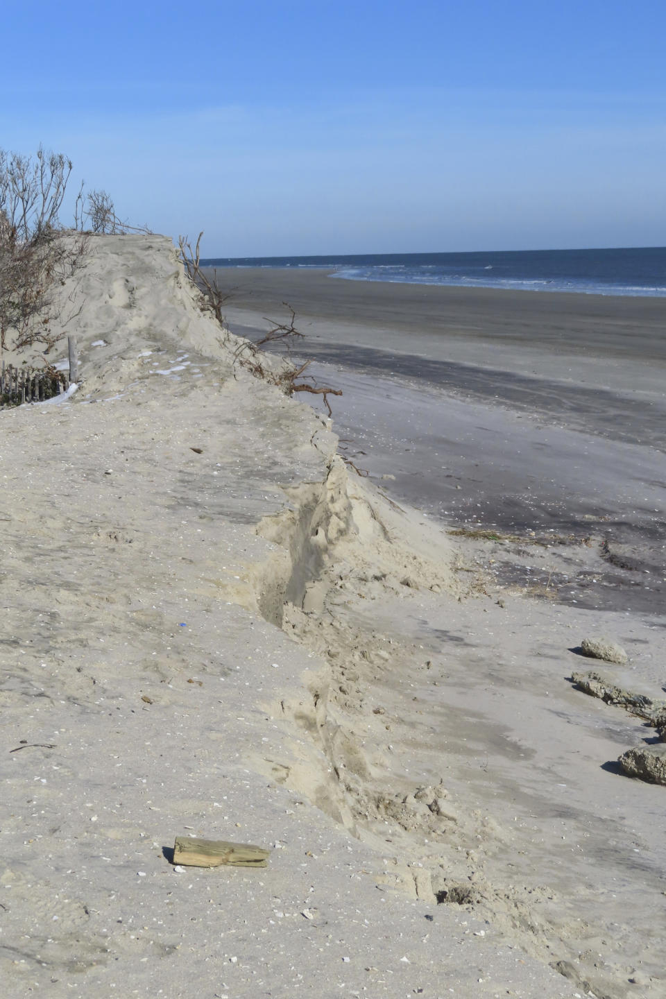 FILE - This Jan. 22, 2024 photo shows a severely eroded section of sand dune in North Wildwood N.J. On April 25, 2024, North Wildwood and the state of New Jersey announced an agreement for an emergency beach replenishment project there to protect the city until a full-blown beach fill can be done by the U.S. Army Corps of Engineers that may still be two years away. Winter storms punched a hole through what is left of the city's eroded dune system, leaving it more vulnerable than ever to destructive flooding. (AP Photo/Wayne Parry, File)