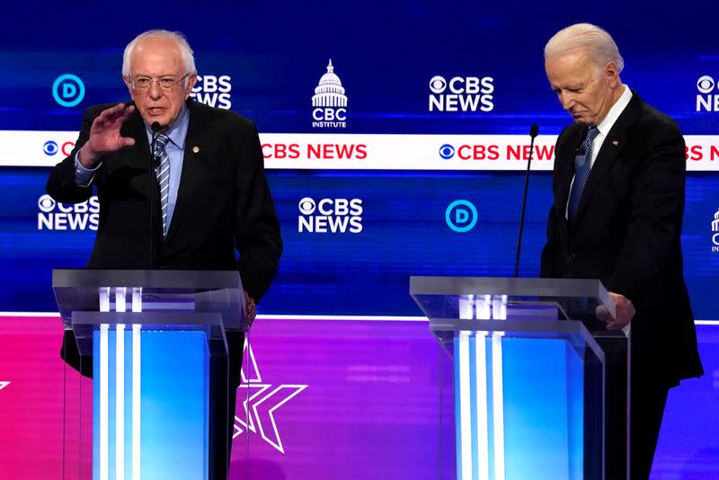 FILE PHOTO: Democratic 2020 U.S. presidential candidates Senator Bernie Sanders makes a point as former Vice President Joe Biden listens at the tenth Democratic 2020 presidential debate at the Gaillard Center in Charleston