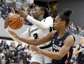 UConn's Aubrey Griffin, right, breaks up a layup attempt by Providence's Grace Efosa (2) during the second half of an NCAA college basketball game, Wednesday, Feb. 1, 2023, in Providence, R.I. (AP Photo/Mark Stockwell)