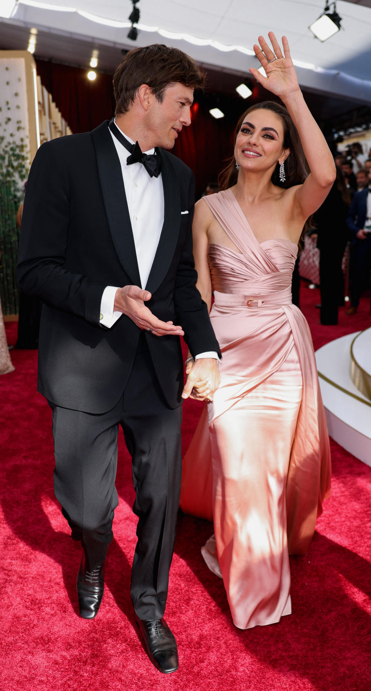 Ashton Kutcher and Mila Kunis pose on the red carpet during the Oscars arrivals at the 94th Academy Awards in Hollywood, Los Angeles, California, U.S., March 27, 2022. REUTERS/Mike Blake