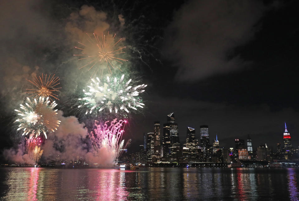 A surprise display of fireworks sponsored by Macy's explode over the Hudson Yards area of Manhattan as seen from a pier in Hoboken, N.J., late Tuesday, June 30, 2020. The fireworks were not announced until an hour or so before to avoid attracting large crowds during the coronavirus pandemic. (AP Photo/Kathy Willens)