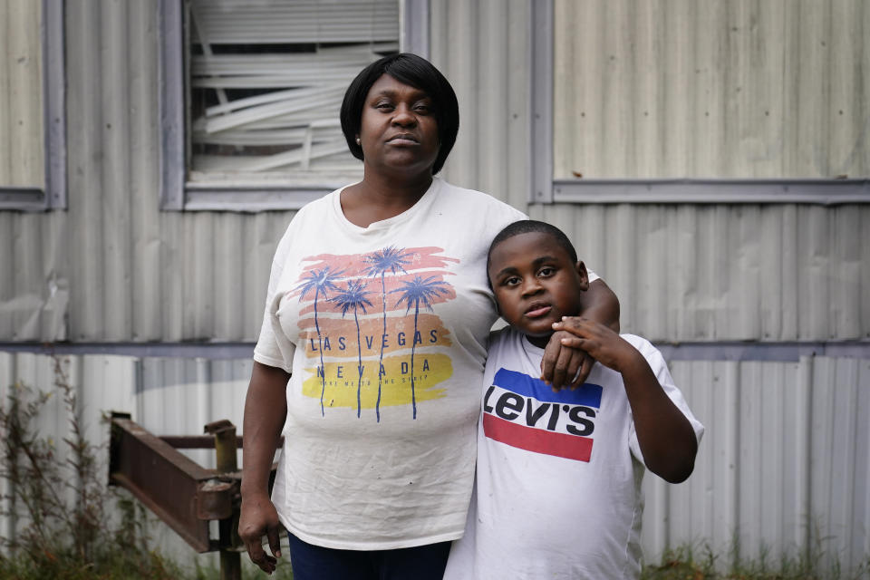 Bontressa Brown, 47, left, and Yuri Brown, 7, right, stand for a portrait outside their home in Sylvester, Ga., on Tuesday, Nov. 14, 2023. “I miss his father daily. He’d have been a great father. He was looking forward for his son. He was a great, great man." (AP Photo/Brynn Anderson)