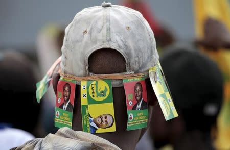 A protester wears a cap with signs of presidential candidates Moise Jean Charles and Jude Celestin during a demonstration against the preliminary results of the presidential elections in Port-au-Prince, Haiti, November 18, 2015. REUTERS/Andres Martinez Casares