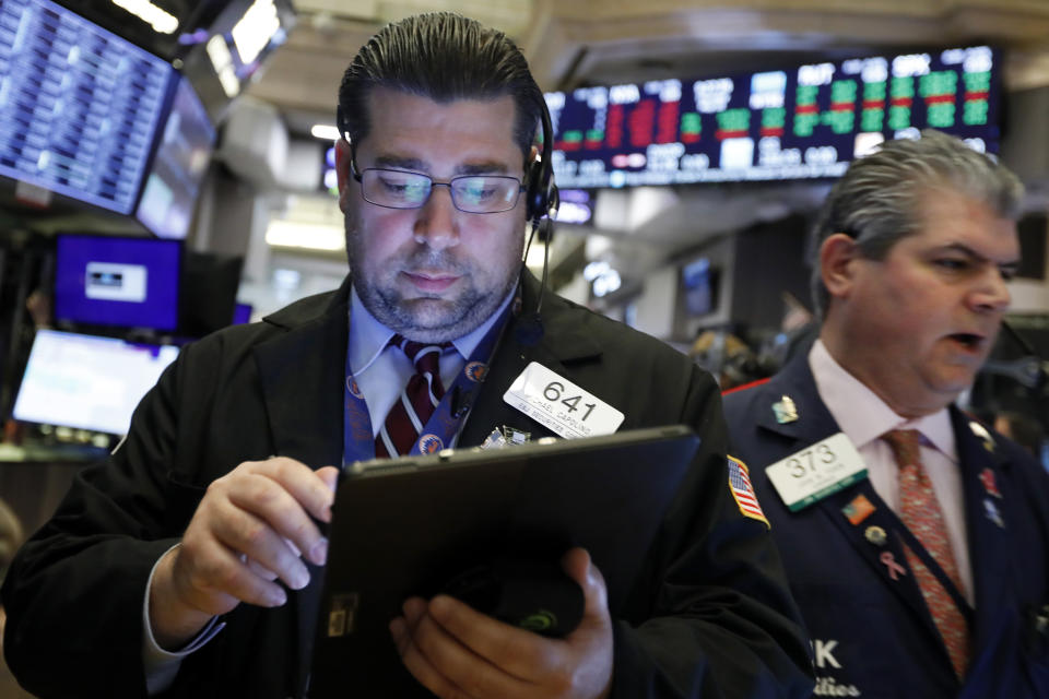 Traders Michael Capolino, left, and John Panin work on the floor of the New York Stock Exchange, Thursday, May 30, 2019. Stocks are edging higher in early trading on Wall Street following two days of losses. (AP Photo/Richard Drew)