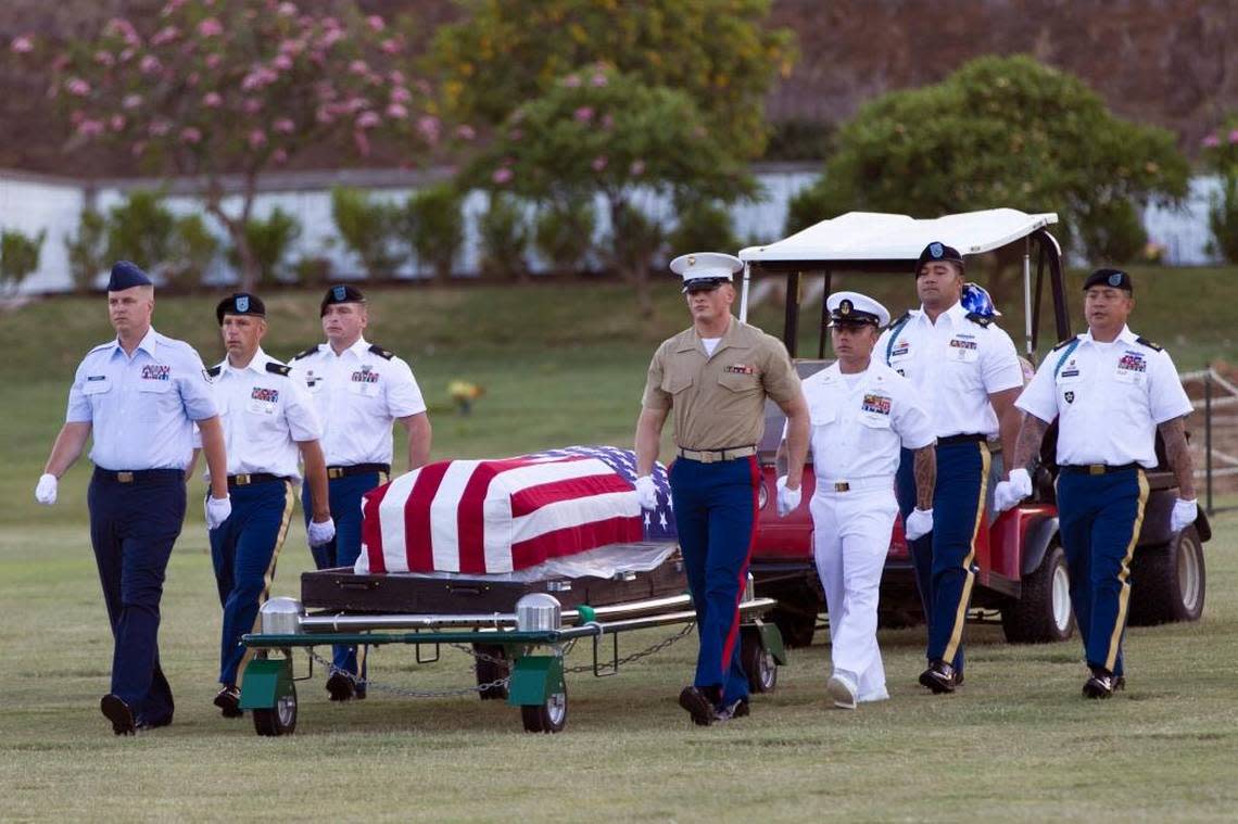 Military pallbearers escort the exhumed remains of unidentified crew members of the USS Oklahoma killed in the 1941 bombing of Pearl Harbor that were disinterred from a gravesite at the National Memorial Cemetery of the Pacific in July, 2015 in Honolulu. The Pentagon hopes to identify the rest of the Oklahoma’s “unknowns,” now estimated to be about 388.