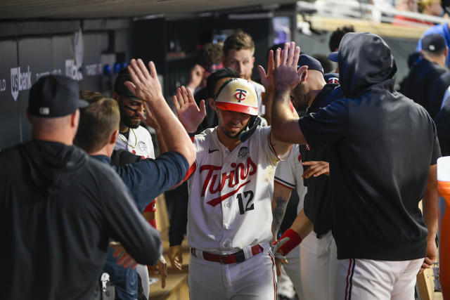 Minnesota Twins' Kyle Farmer (12) tosses his bat after striking