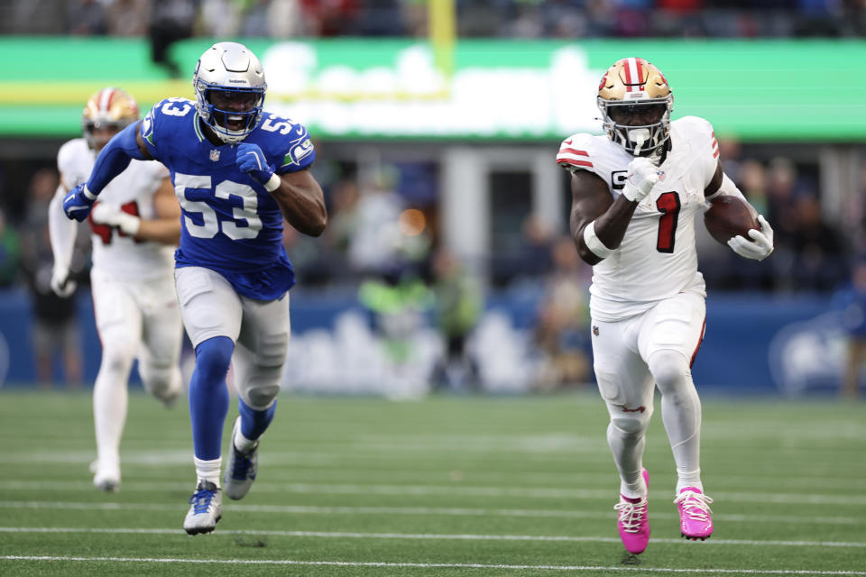 Deebo Samuel Sr. of the San Francisco 49ers runs the ball for a touchdown for Boye Mafe (53) of the Seattle Seahawks. (Photo by Steph Chambers/Getty Images)