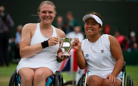 Japan's Yui Kamiji (R) and Britain's Jordanne Whiley pose with their winner's trophy after winning against Netherlands' Marjolein Buis and Netherlands' Diede De Groot - Credit: DANIEL LEAL-OLIVAS/AFP/Getty Images