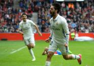 Real Madrid's Isco (R) celebrates after scoring a goal during their match against Real Sporting de Gijon at El Molinon stadium in Gijon on April 15, 2017