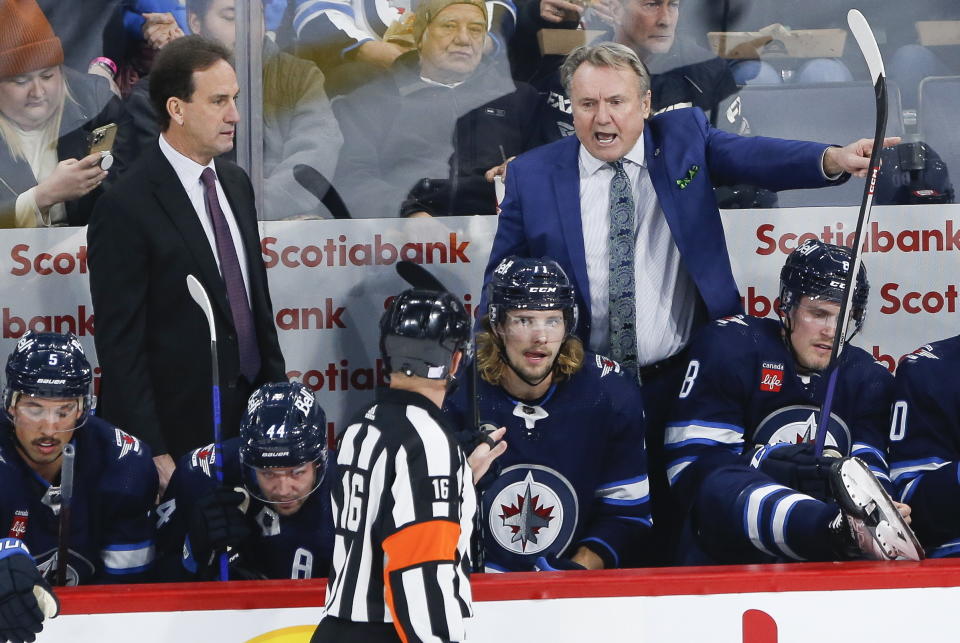 Winnipeg Jets head coach Rick Bowness, upper right, yells at a referee during second-period NHL hockey game action against the Pittsburgh Penguins in Winnipeg, Manitoba, Saturday, Nov. 19, 2022. (John Woods/The Canadian Press via AP)