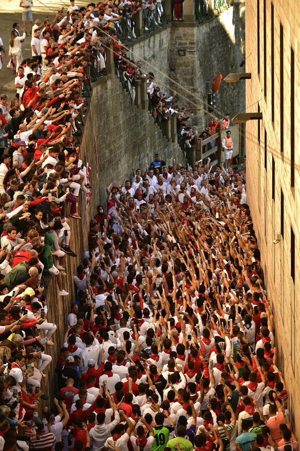 People pray to Saint Fermin, ahead of the running of the bulls at the San Fermin Festival in Pamplona, northern Spain, Friday, July 8, 2022. Revellers from around the world flock to Pamplona every year for nine days of uninterrupted partying in Pamplona's famed running of the bulls festival, which was suspended for the past two years due to the coronavirus pandemic. (AP Photo/Alvaro Barrientos)