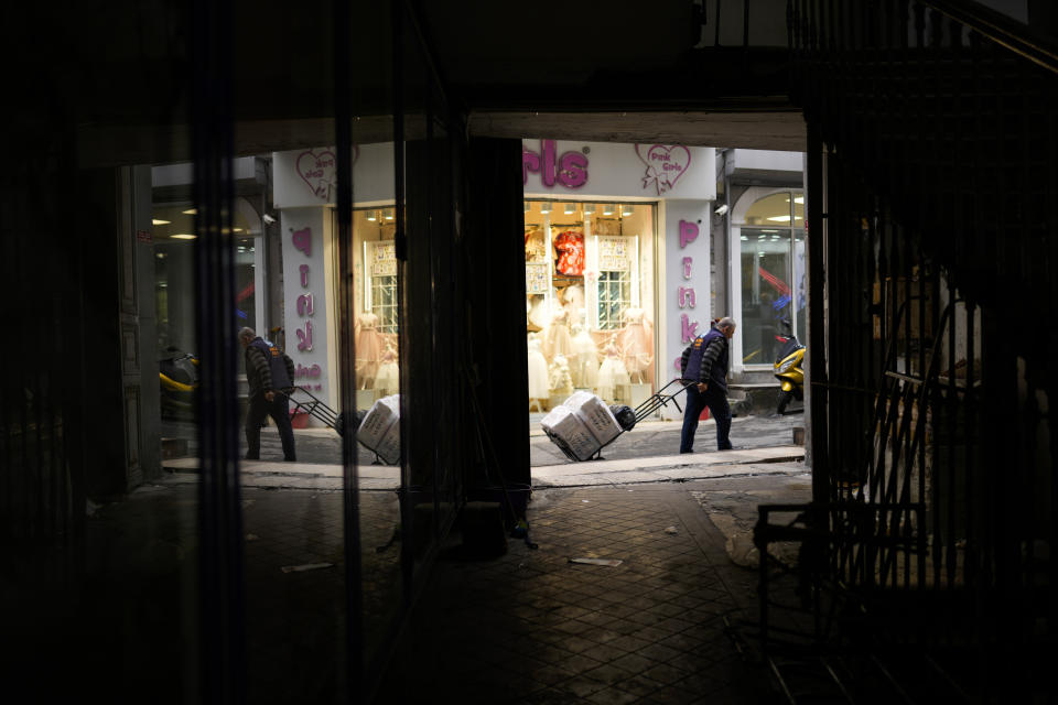 A man pulls a trolley with goods in a commercial area in Istanbul, Turkey, Tuesday, Nov. 2, 2021. Many Turkish consumers are faced with increased hardship as prices of food and other goods have soared in recent years. The yearly consumer price index increased by 19.9% in October, up from 19.58% in September, according to official data by the Turkish Statistical Institute released on Nov. 3. (AP Photo/Francisco Seco)