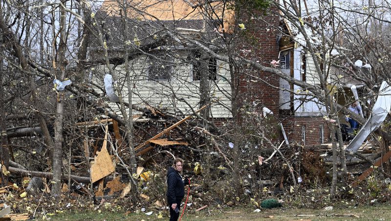 Toni Jackson is overcome with emotion as she walks her dog past damaged homes, Sunday, Dec. 10, 2023, in Clarksville, Tenn. Tornadoes caused catastrophic damage in Middle Tennessee on Saturday afternoon and evening, Dec. 9.