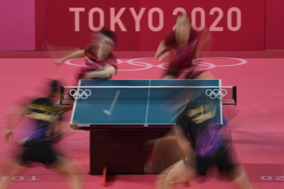 Japan’s Mima Ito, left, and Jun Mizutani compete during the table tennis mixed doubles gold medal match against China’s Xu Xin and Liu Shiwen.