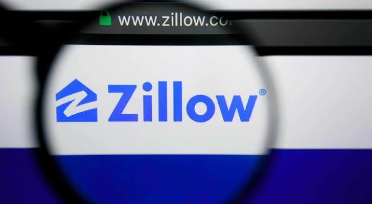 The Zillow logo displayed on a web browser and magnified by a magnifying glass