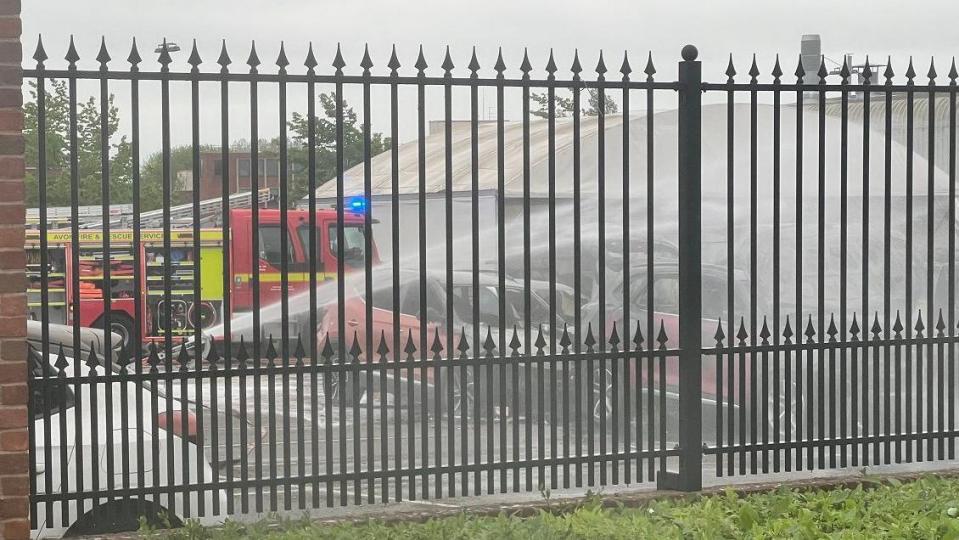 Fire engines spraying water on vehicles close to the A38 in Patchway in Bristol