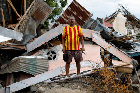 Khairuddin, 49, stands in front of his destroyed house hit by an earthquake, in Balaroa neighbourhood, Palu, Central Sulawesi, Indonesia, October 11, 2018. REUTERS/Jorge Silva